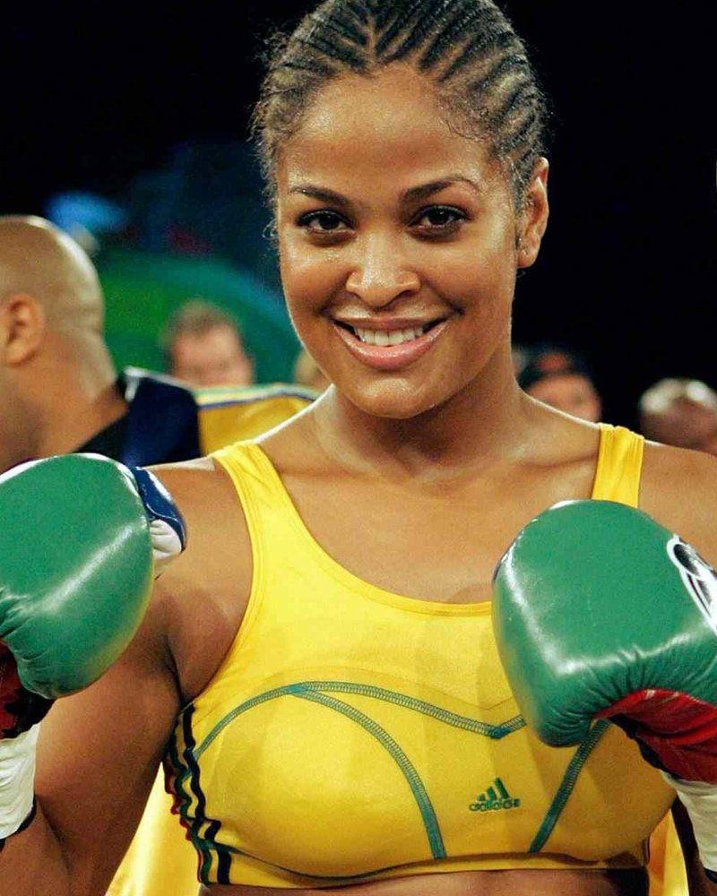 Laila Ali smiling, gloves up, in the ring