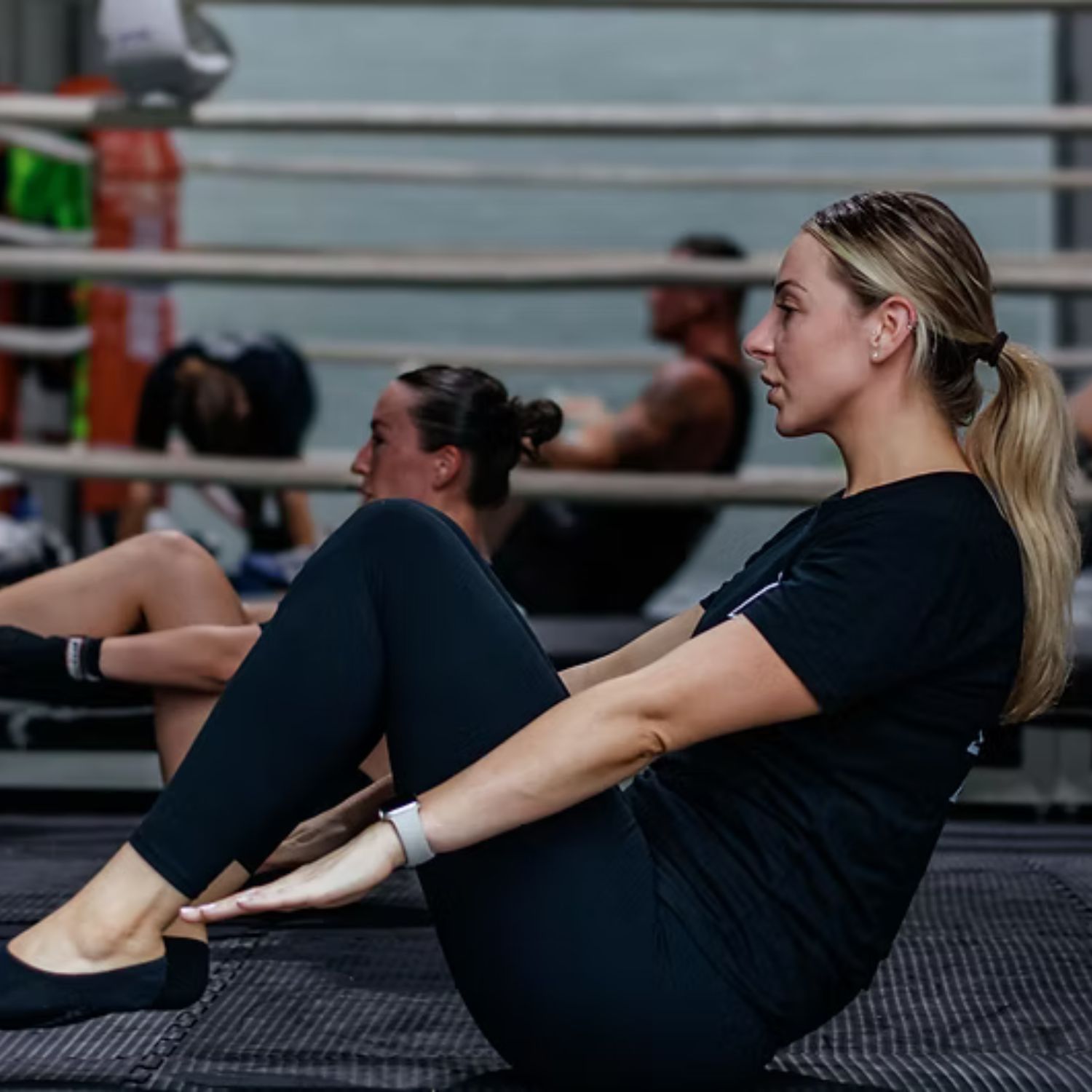 A woman doing core conditioning during a class