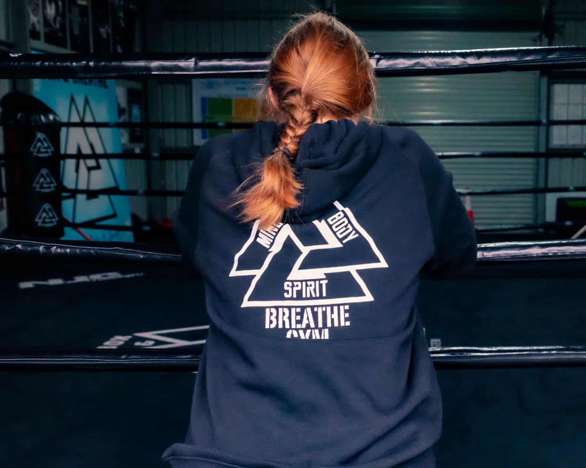 A woman in Box & Breathe gear facing the ring